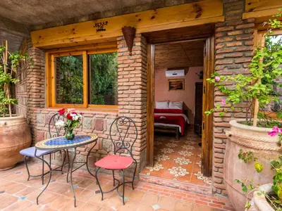 a patio with chairs and a table and a couch at Hotel Bin El Ouidane in Bine el Ouidane