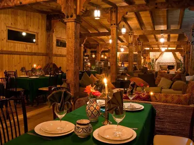 a dining room with a table with a green table cloth at Hotel Bin El Ouidane in Bine el Ouidane