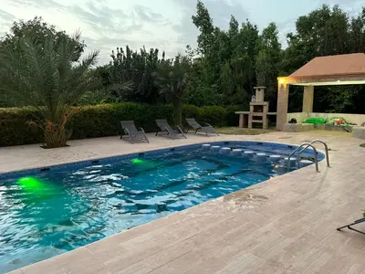 a swimming pool with chairs in a yard at Oasis Oumifis in Marrakech