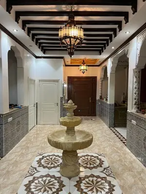 a large foyer with a fountain in the middle at Oasis Oumifis in Marrakech