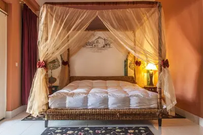 a bed with a canopy in a bedroom at Villa Yasmina in Douar Blidene