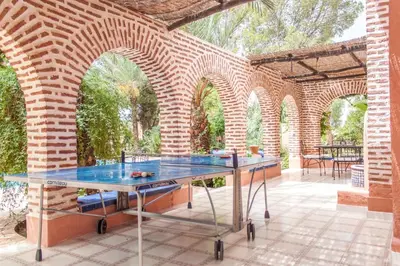 an outdoor ping pong table on a brick patio at Villa Yasmina in Douar Blidene