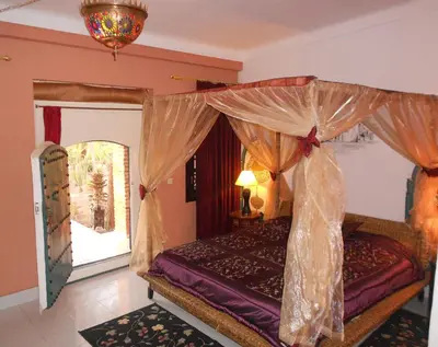 a bedroom with a canopy bed and a window at Villa Yasmina in Douar Blidene