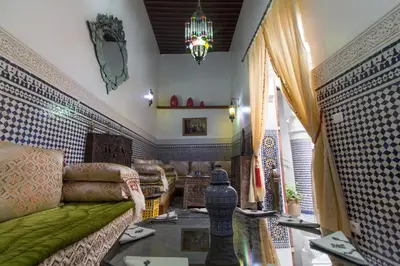 a living room with a couch and a table at Riad Sanaa Rose in Fès