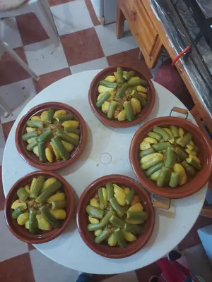four bowls of fruit on a white table at Riad ma bonne étoile in Kasr Bounou