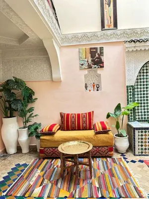 a living room with a couch and a table at Dar Khmissa Fes-Luxury Stay Fes Medina in Fès
