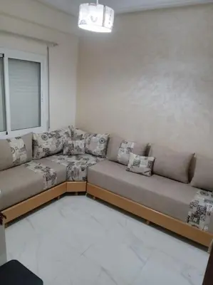 a living room with two couches and a window at Appart prestigieux+T bien équipé in Fès