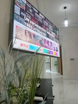 a large television hanging on a wall in a room at Appart prestigieux+T bien équipé in Fès