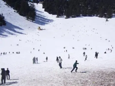 a group of people on a snow covered ski slope at Riad Azrou in Azrou
