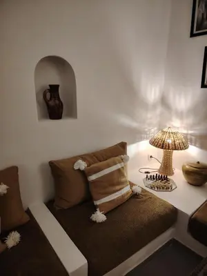 a room with a couch and a table with a lamp at La Maison des Amis in Fès
