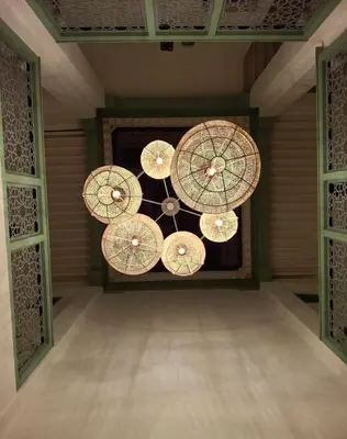 a room with several umbrellas hanging from a ceiling at La Maison des Amis in Fès