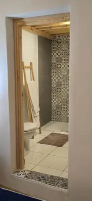 a bathroom with a toilet and a tiled floor at La Maison des Amis in Fès
