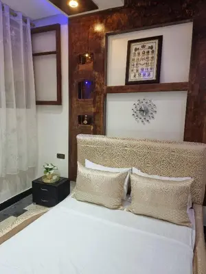 a bedroom with a bed with white sheets and pillows at Fassia in Fès