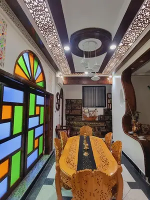 a dining room with a table and stained glass windows at Fassia in Fès