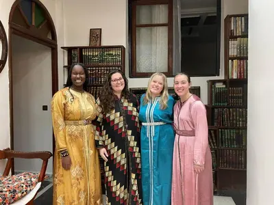 four women posing for a picture in a library at Fassia in Fès