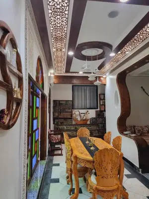 a dining room with a table and chairs at Fassia in Fès