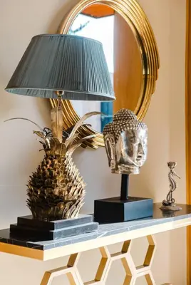 a lamp on a table next to a mirror at Dar ilyan in Marrakech