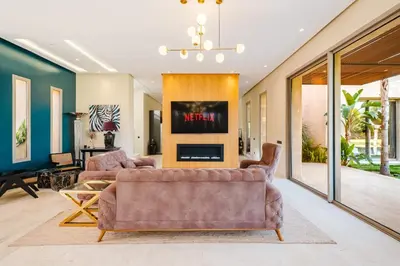 a living room with a couch and a tv at Dar ilyan in Marrakech