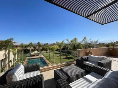 a patio with couches and a swimming pool at Dar ilyan in Marrakech