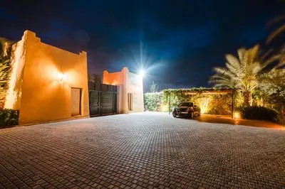 a car parked in front of a house at night at Dar ilyan in Marrakech