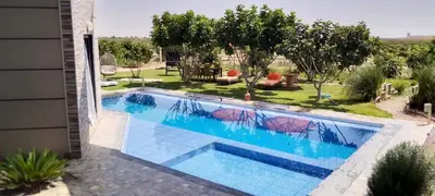 a swimming pool in the backyard of a house at Ferme Marsa in Guercif