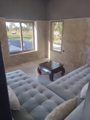 a living room with a couch and a coffee table at Ferme Marsa in Guercif