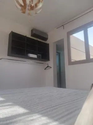 a bedroom with a bed and a window at Ferme Marsa in Guercif