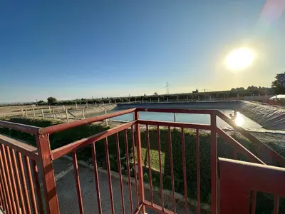 a balcony with a railing with a view of a body of water at Ferme Marsa in Guercif