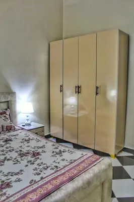a bedroom with a bed and a large cabinet at Yassers Residence in Er Rachidia