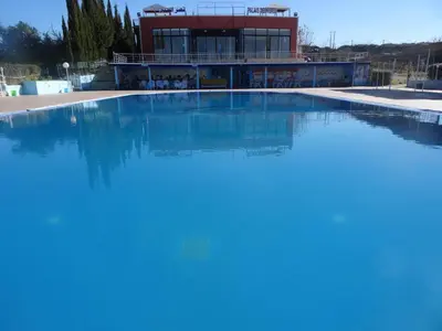 a large swimming pool in front of a building at Tahla Garden in Tahla