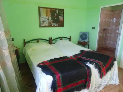 a bedroom with a bed with a blanket on it at Tahla Garden in Tahla