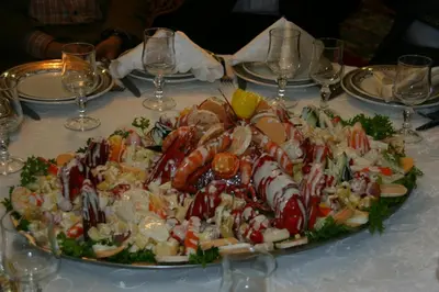 a large plate of food on a table with wine glasses at Tahla Garden in Tahla
