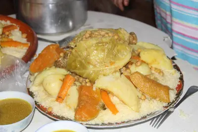 a plate of food with vegetables on a table at Tahla Garden in Tahla
