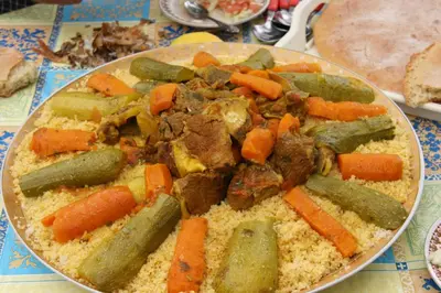 a plate of food with meat and vegetables on a table at Tahla Garden in Tahla