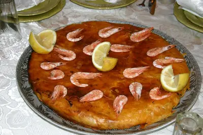a cake with shrimp and lemon slices on a table at Tahla Garden in Tahla