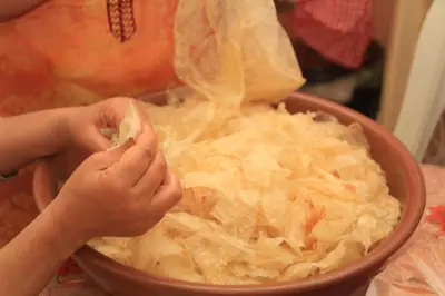 a child is holding a bowl of food at Tahla Garden in Tahla
