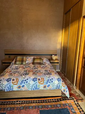 a bedroom with a bed with a book on it at Motia's farm in Marrakech