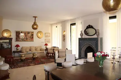 a living room with a couch and a fireplace at Dar Lalla Mhalla Villa 975m2 5ch - Rt de Fes in Marrakech