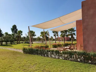 a pavilion with tables and chairs in a park at Dar Lalla Mhalla Villa 975m2 5ch - Rt de Fes in Marrakech