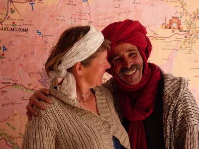 a man and a woman standing in front of a map at Alliance Berbère - Vallée d'Aït Bouguemez in Timit