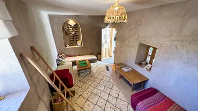 an overhead view of a living room with a table and chairs at Alliance Berbère - Vallée d'Aït Bouguemez in Timit