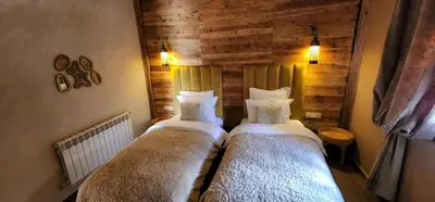 a bedroom with two beds in a room at Chalets-Appartements Tourtite in Ifrane