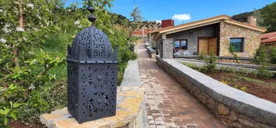 a metal object on a brick walkway next to a house at Chalets-Appartements Tourtite in Ifrane