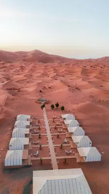 an aerial view of a desert with white buildings at Diament Luxury Camp-Sahara Desert Experience in Merzouga in Merzouga