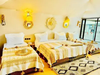 a bedroom with two beds and mirrors on the wall at Diament Luxury Camp-Sahara Desert Experience in Merzouga in Merzouga