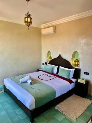 a bedroom with a large bed in a room at Riad Timskrine in Ourika