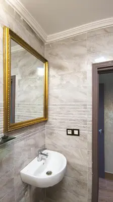 a bathroom with a sink and a mirror at Hôtel La Chambotte in Imouzzer Kandar
