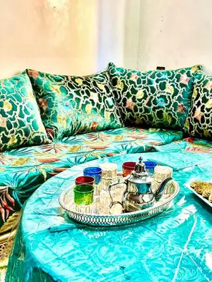 a table with a tray of teaiments on a couch at Cozy Host House with 2 air conditioned rooms in Er Rachidia
