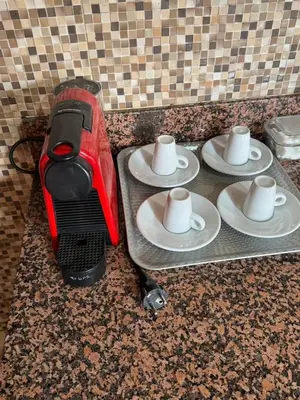 three plates with coffee cups on a kitchen counter at Cozy Host House with 2 air conditioned rooms in Er Rachidia