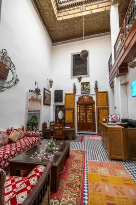 a living room with a couch and a table at Riad Fes Allouch in Fès